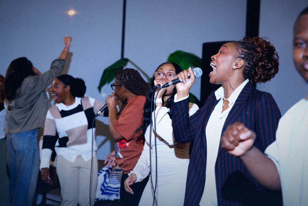 Worship team singing with raised fists