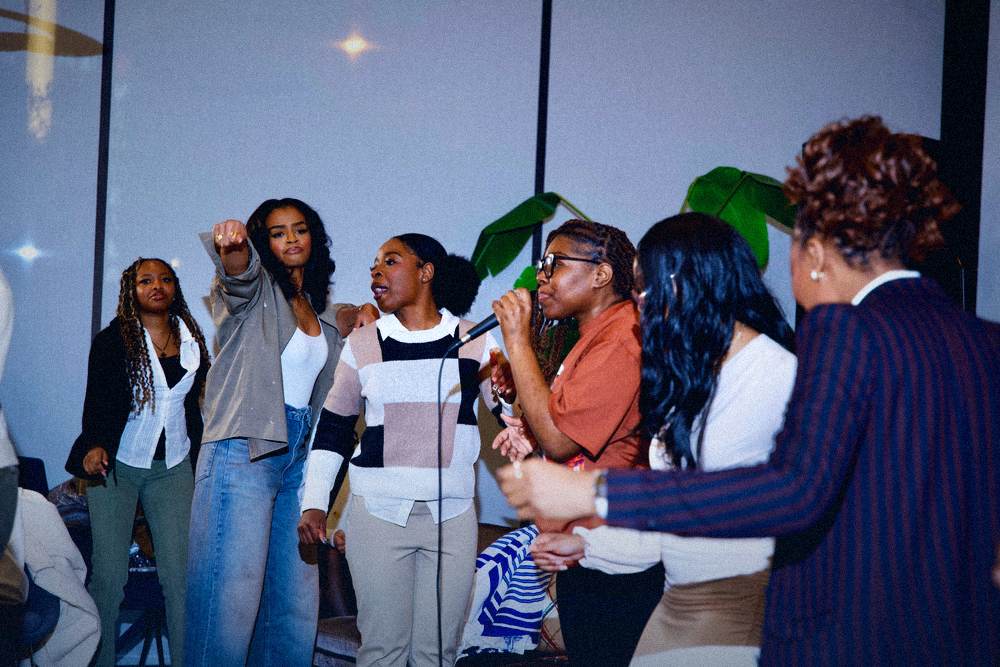 Worship team singing together on stage