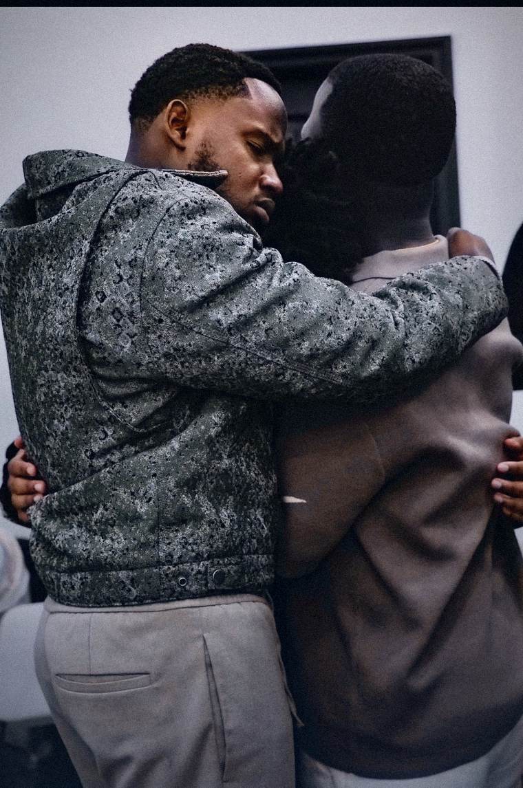 Two men embracing in prayer