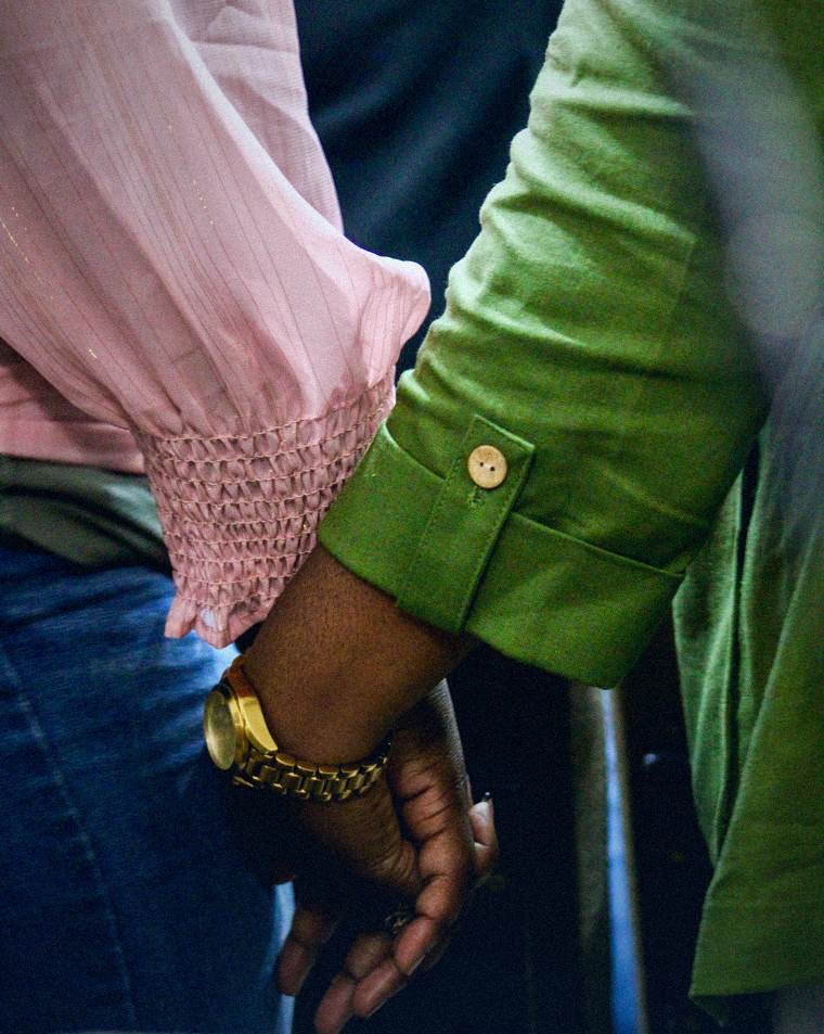 Two people holding hands