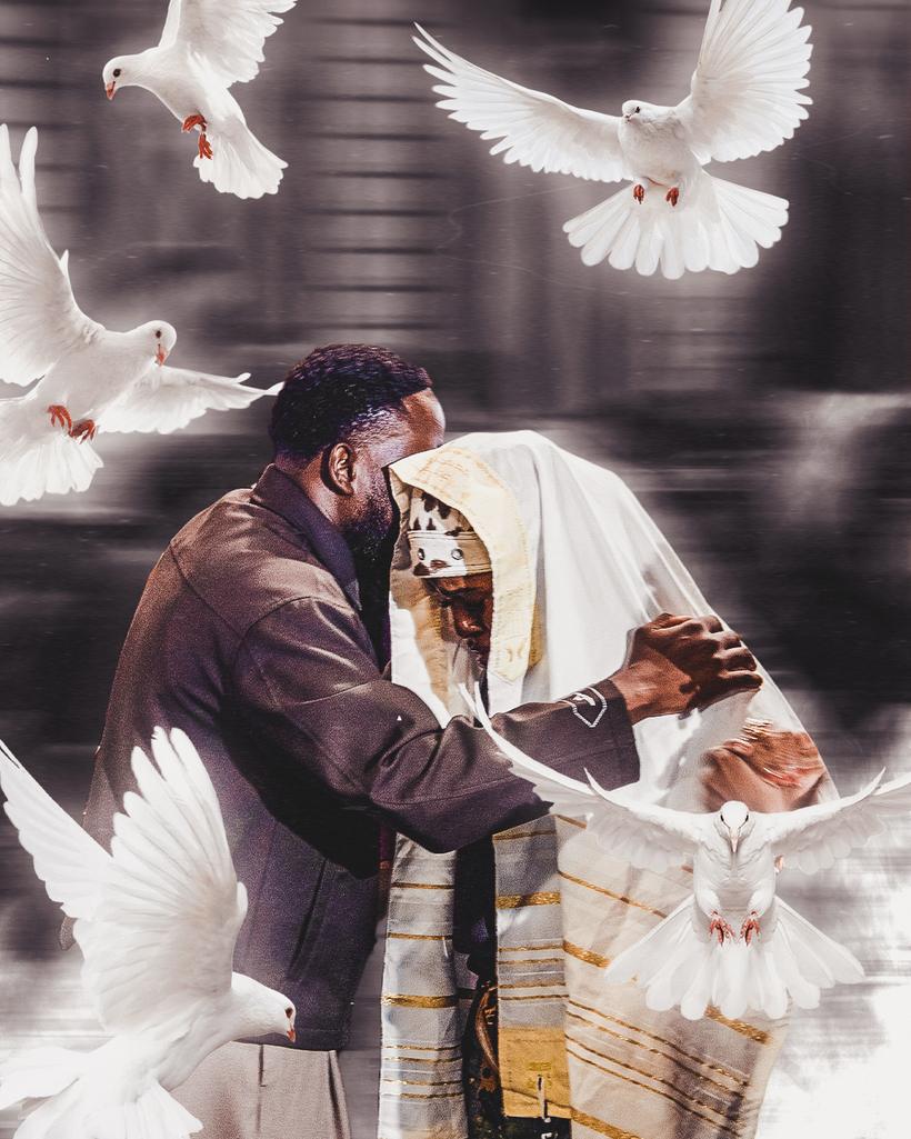 Davins Manasse praying over a believer wrapped in a prayer shawl, with white doves around them